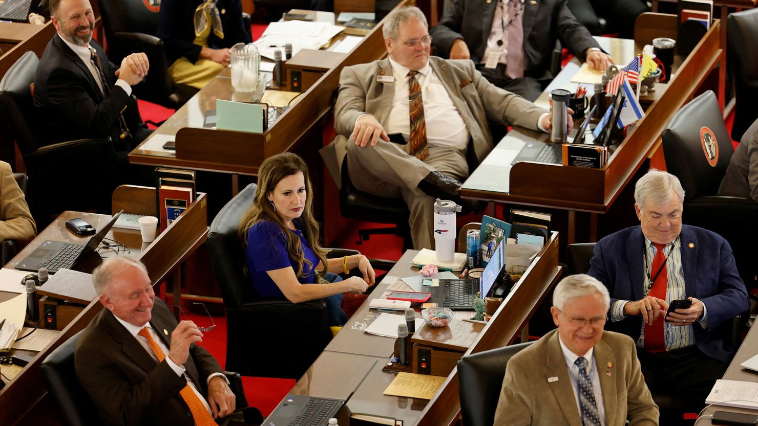 Tricia Cotham, whose recent defection from the Democratic Party handed their opponents a super majority, is surrounded by fellow Republicans in North Carolina's House of Representatives before it approved the SB20 bill limiting most abortions to the first trimester of pregnancy, a sharp drop from the state's current limit of 20 weeks gestation, at the State Capitol in Raleigh, North Carolina, May 3, 2023.