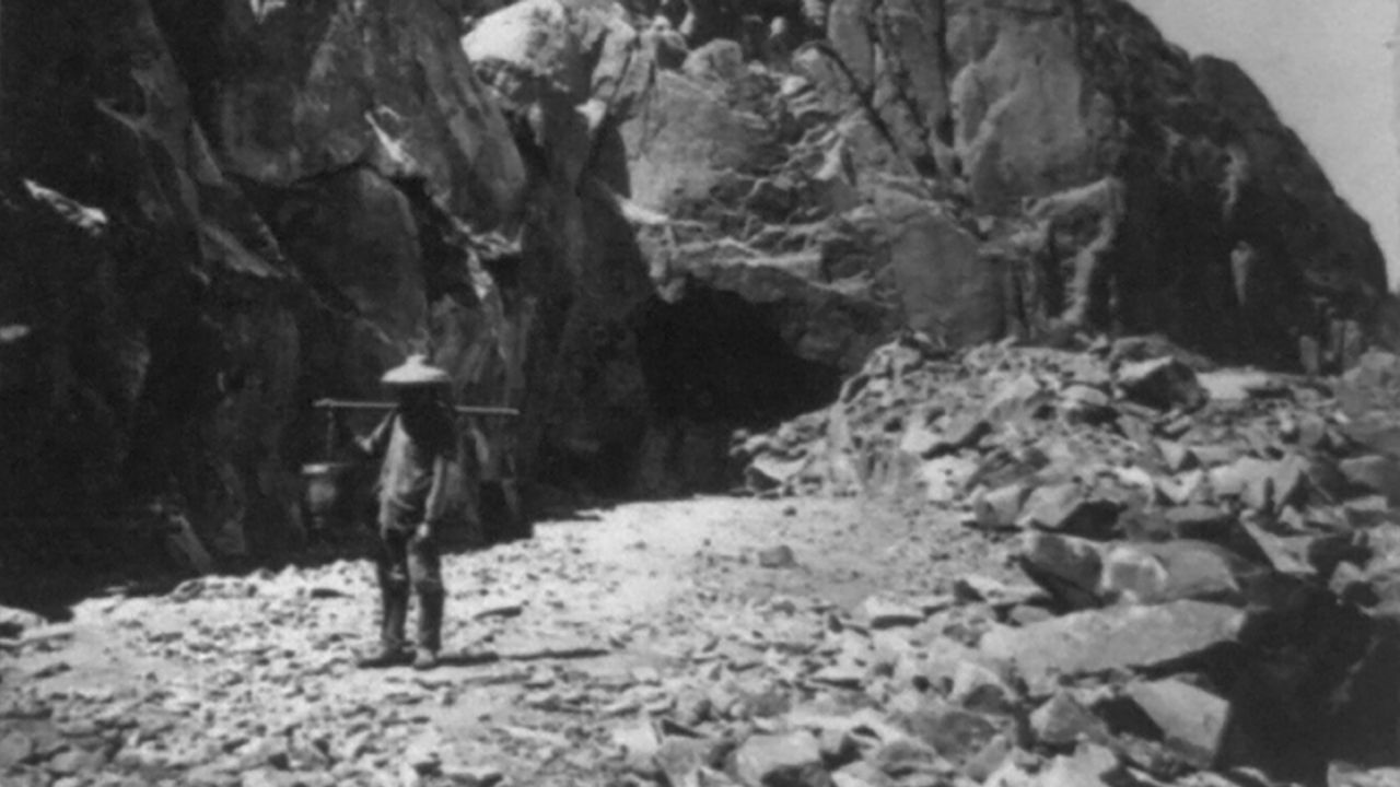 A Chinese railroad worker in California holds a shoulder pole in an undated photo from the 1800s.