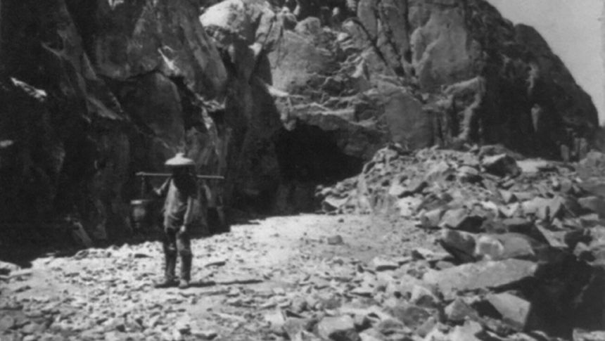 Heading of east portal Tunnel No. 8. Central Pacific Railroad, California Photograph shows Chinese railroad worker with a shoulder pole.