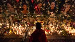 MONTEREY PARK, CALIFORNIA - JANUARY 25: A young woman lights incense at a growing vigil for 11 people murdered during a mass shooting at Star Ballroom Dance Studio in Monterey Park, California. (Photo by Barbara Davidson/Getty Images)