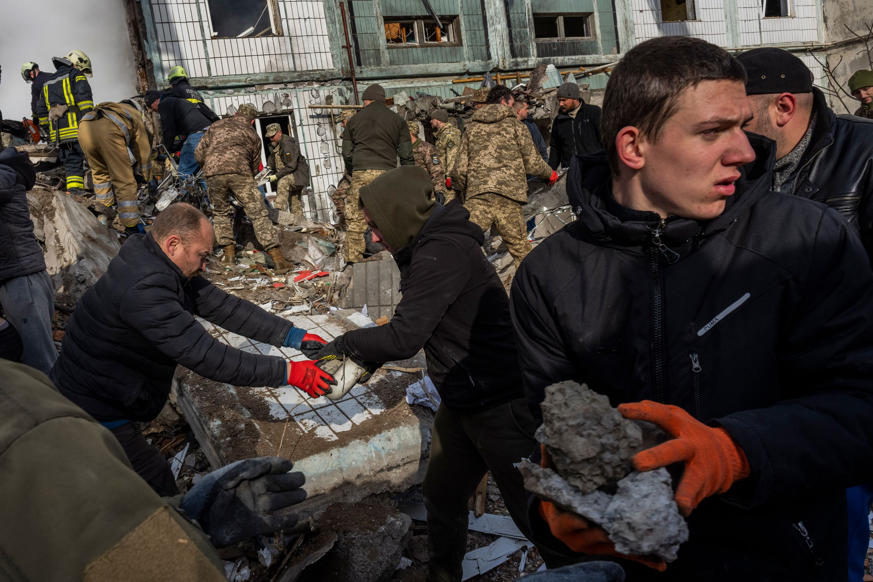 First responders remove rubble from a residential building after a Russian missile strike in Uman, Ukraine.