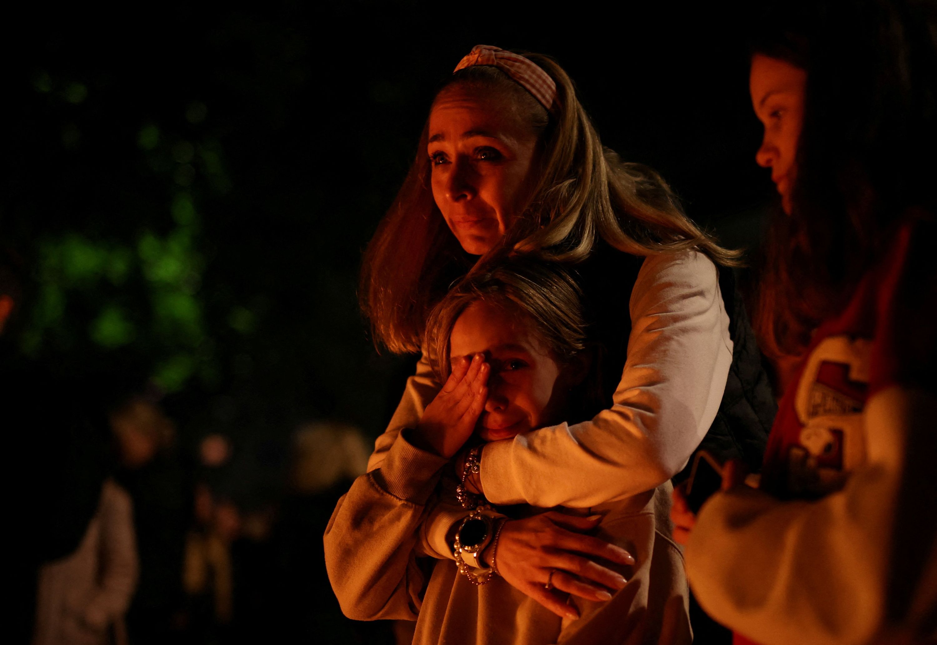 A mother and child react outside of a school in Belgrade, Serbia, after a mass shooting occurred.