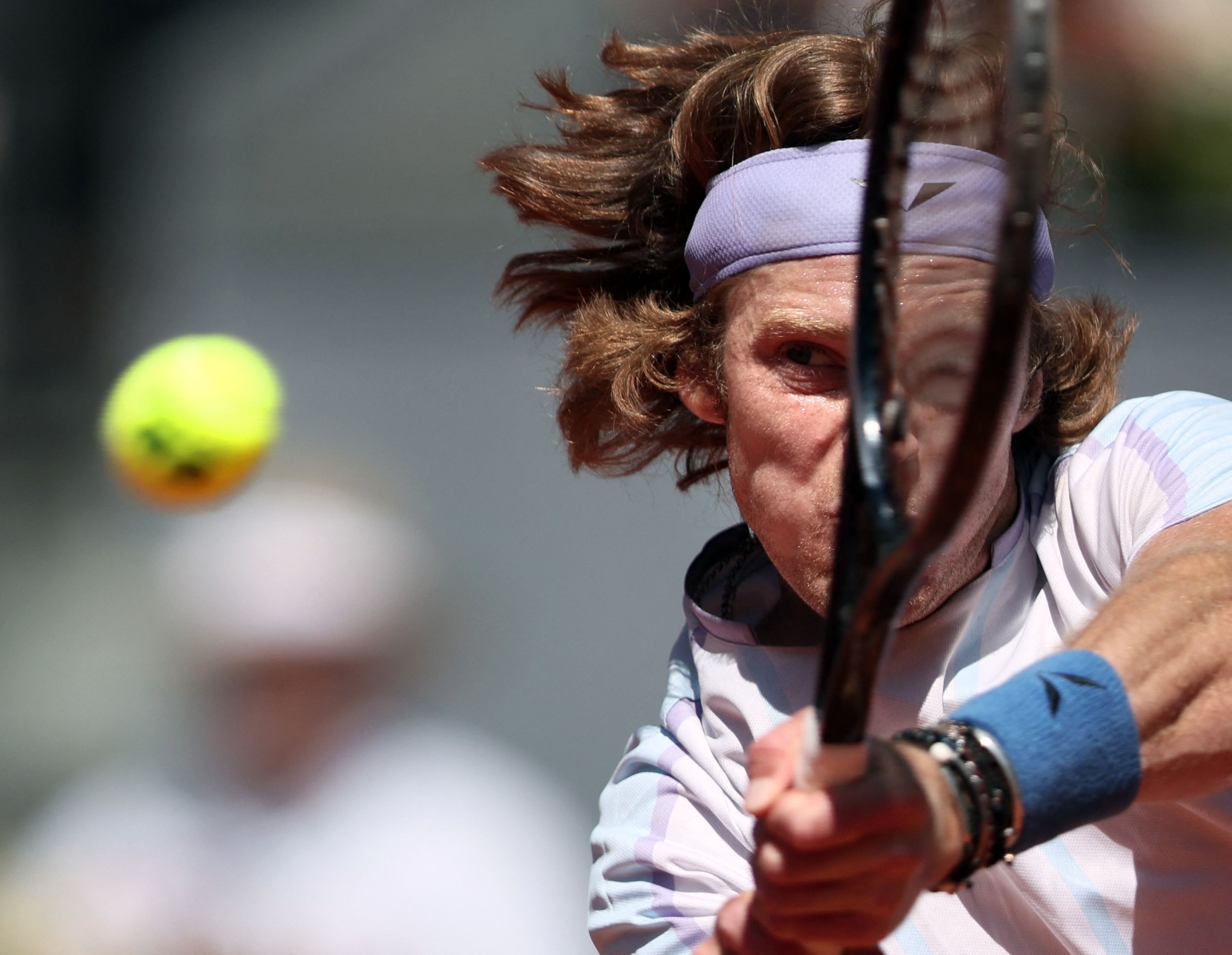 Andrey Rublev returns a ball during his match at the Madrid Open.