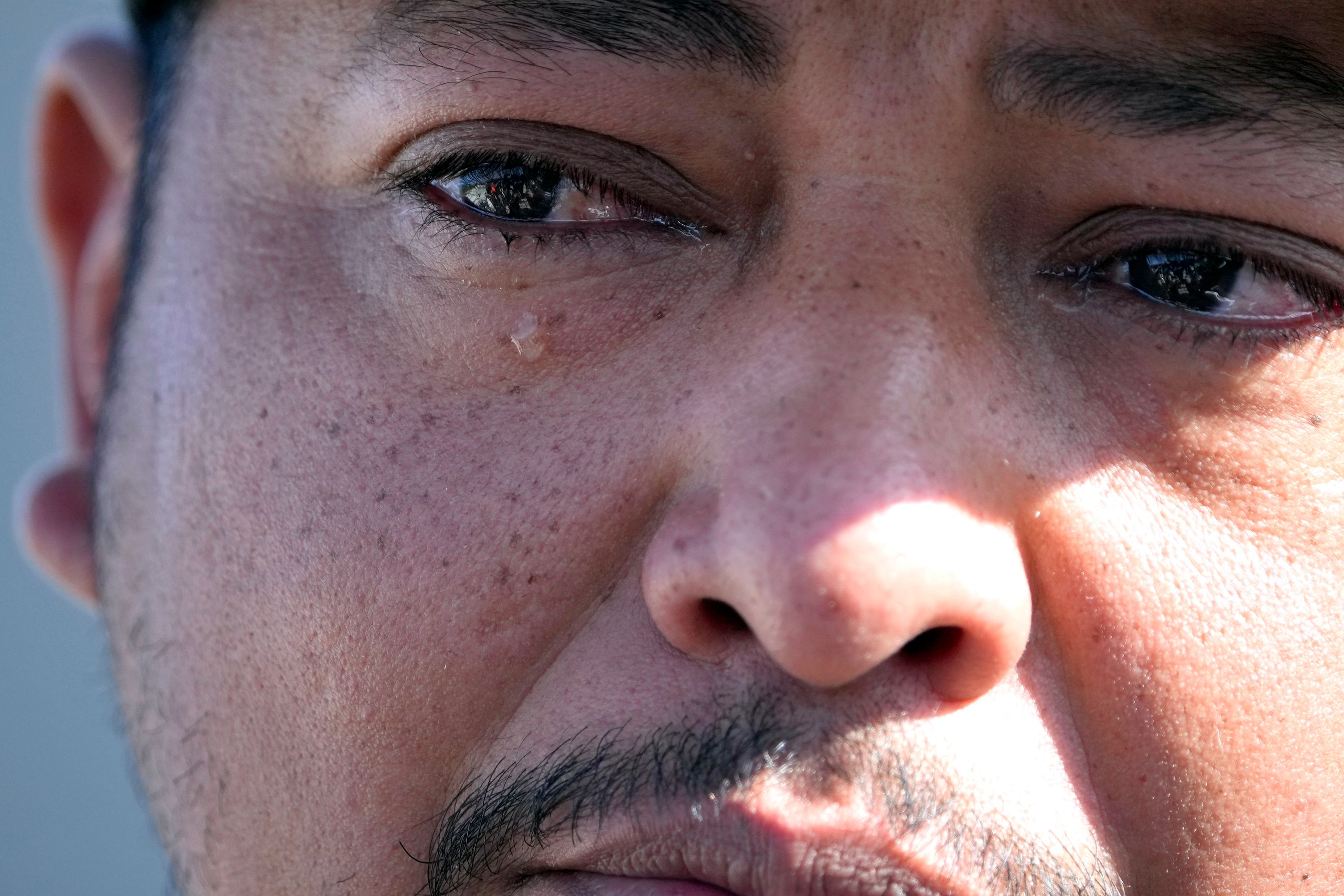 Wilson Garcia reacts while discussing the tragedy of his family's loss in a shooting in Cleveland, Texas.