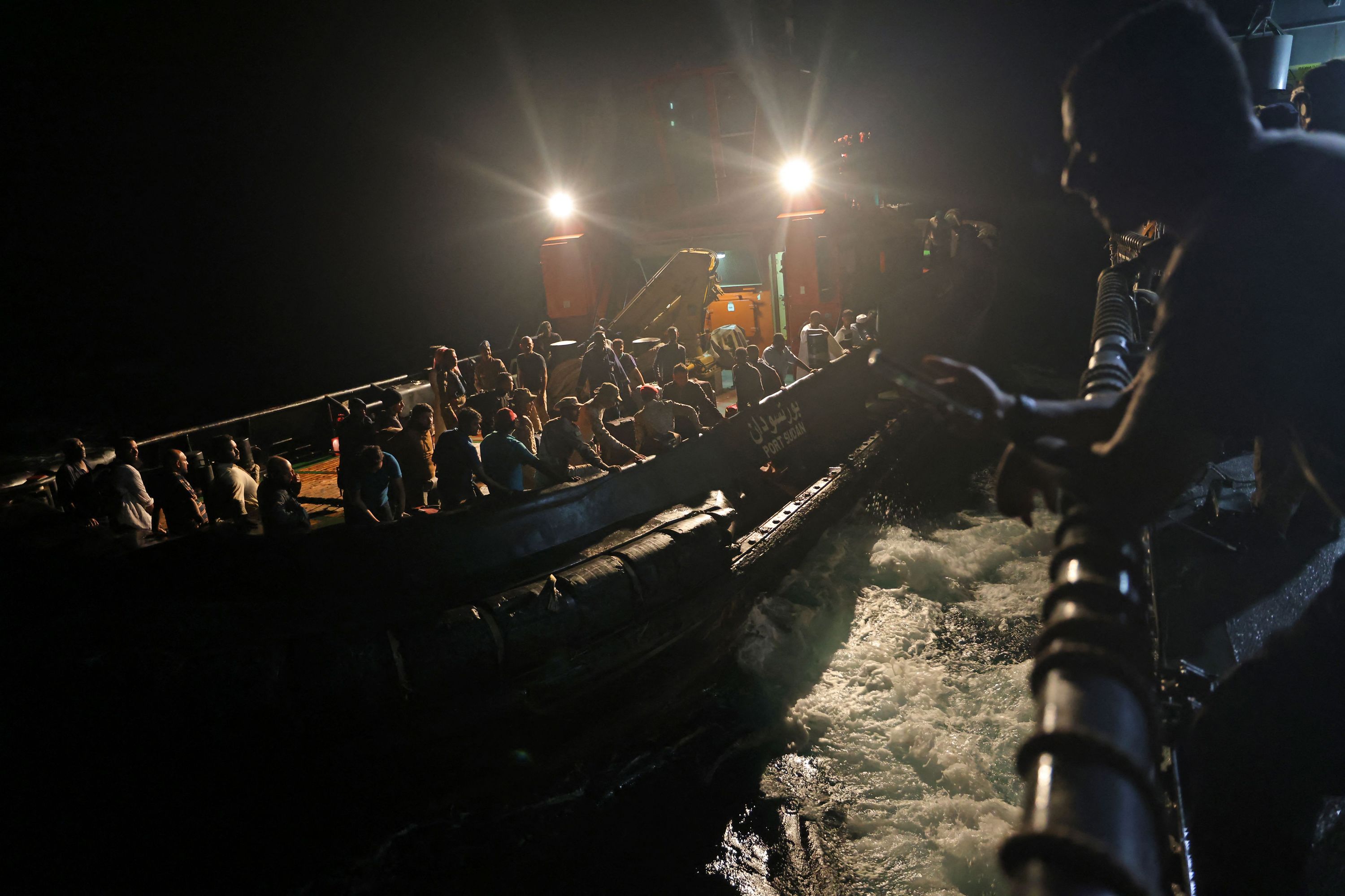 Evacuees are being transported aboard a tugboat in Sudan.