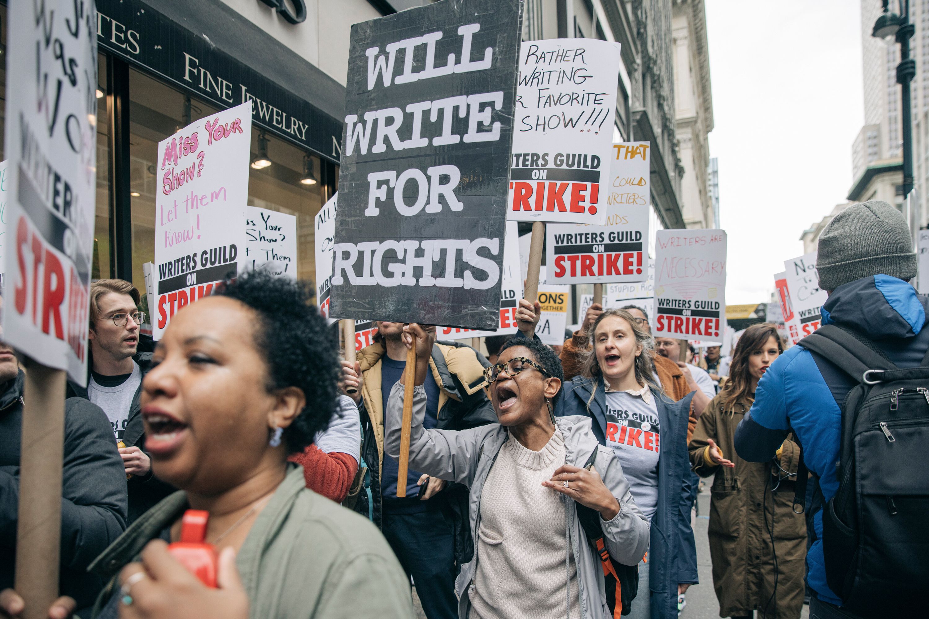 Members of the Writers Guild of America walk the picket line during a strike.