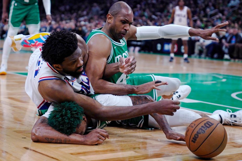 Philadelphia 76ers center Joel Embiid battles for a loose ball with Boston's Al Horford, right, and Marcus Smart during an NBA playoff game on Wednesday, May 3. Embiid was named the league's <a href="https://www.cnn.com/2023/05/02/sport/joel-embiid-nba-mvp-2023-philadelphia-76rs/index.html" target="_blank">Most Valuable Player</a> for his play during the regular season.