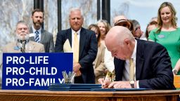 Gov. Greg Gianforte signs a suite of bills aimed at restricting access to abortion during a bill signing ceremony on the steps of the State Capitol, in Helena, Mont., on Wednesday, May 3, 2023. (Thom Bridge/Independent Record via AP)