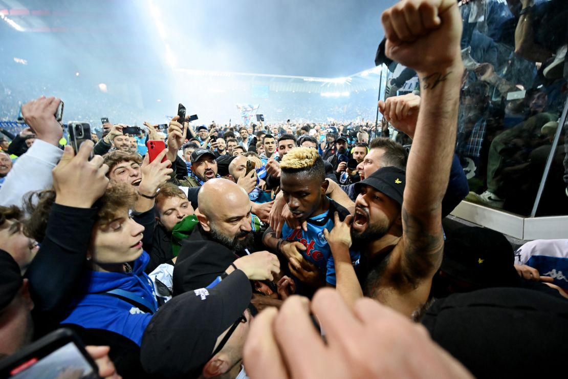 Osimhen is surrounded by Napoli fans after the team wins the Serie A title.