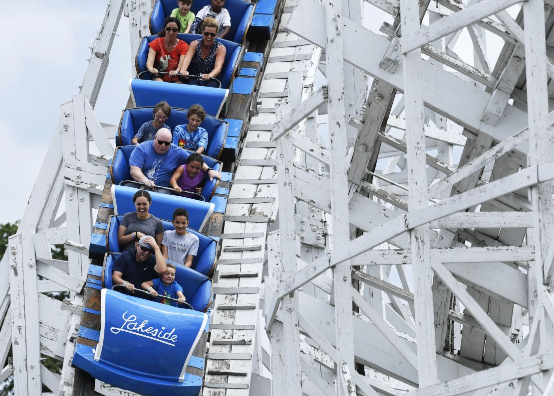 Thrill-seekers head down the first decent on the iconic Cyclone wooden rollercoaster at Lakeside Amusement Park on July 14, 2017, in Denver, Colorado.