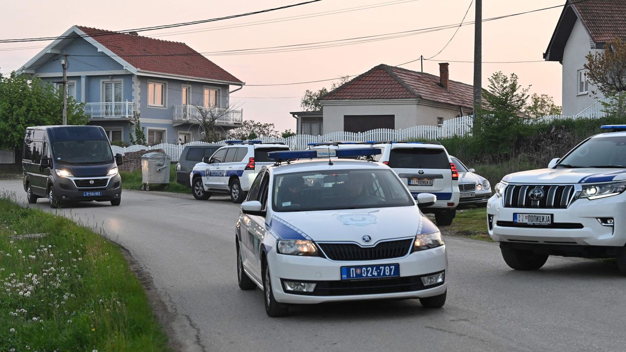 Police block a road in the village of Dubona near the town of Mladenovac, about 60 kilometres (37 miles) south of Serbia's capital Belgrade, on May 5, 2023, after at least eight people were killed and 13 injured in a drive-by shooting. - Near Mladenovac on May 4, 2023, an attacker armed with an automatic weapon opened fire from a moving vehicle before fleeing, state-run RTS television reported. Police were searching for the attacker. (Photo by ANDREJ ISAKOVIC / AFP) (Photo by ANDREJ ISAKOVIC/AFP via Getty Images)