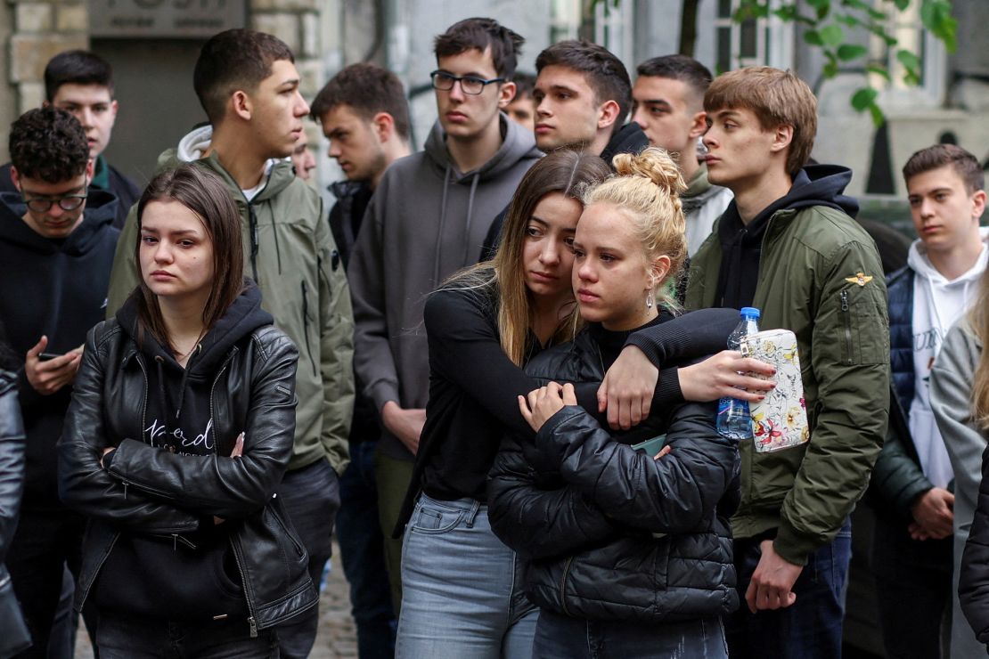 Mourners attend a makeshift memorial in Belgrade following the shooting on Wednesday. 