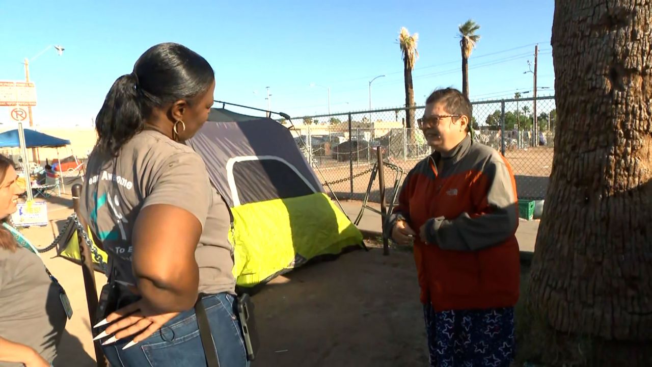 Stefanie Powell, right, lives in a tent at a homeless encampment in Phoenix.