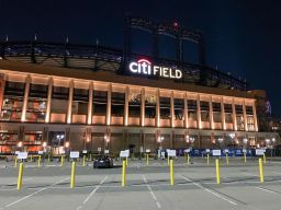 Parking lots at the Mets baseball stadium at Citi Field is one of the places being considered to house migrants ahead of an expected surge.