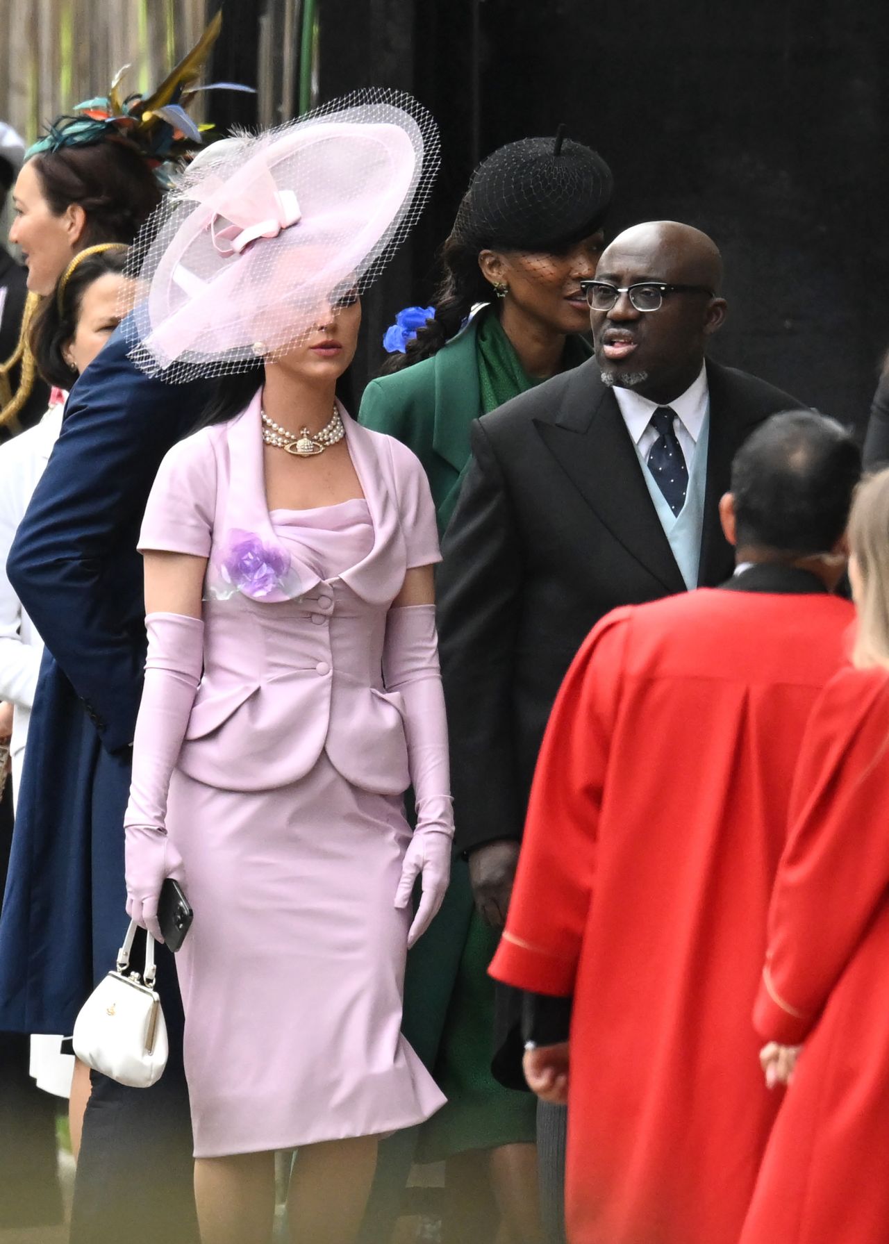Katy Perry and Edward Enninful arrive in his-and-hers baby pink and blue looks.
