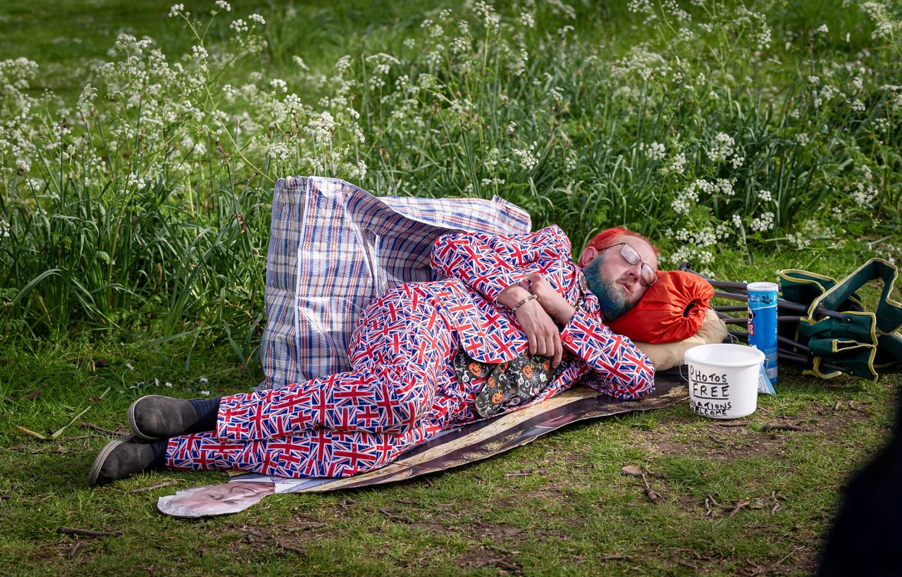 A man rests on the Mall in London a day before the coronation.