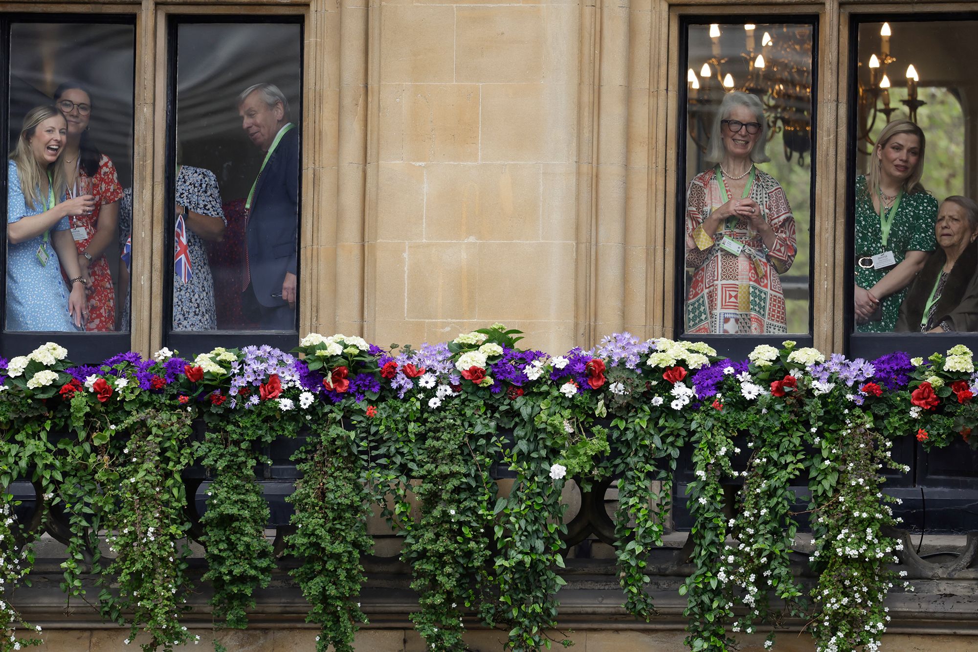 Members of the public look out onto Parliament Square ahead of the coronation.