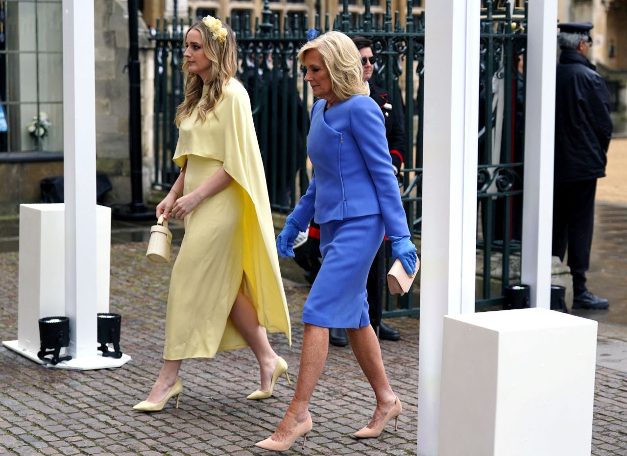First Lady Jill Biden and her grand daughter Finnegan Biden arriving at Westminster Abbey, dressed in yellow and blue.