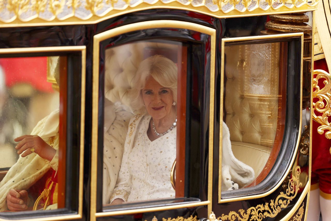 Queen Camilla arriving in the Diamond Jubilee Coach wearing her ermine Robe of State.
