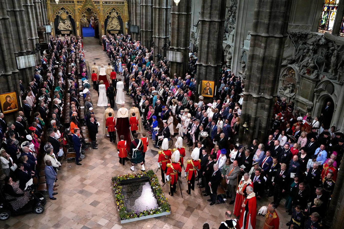 The King, center, and Queen Camilla, front center, arrive at Westminster Abbey.