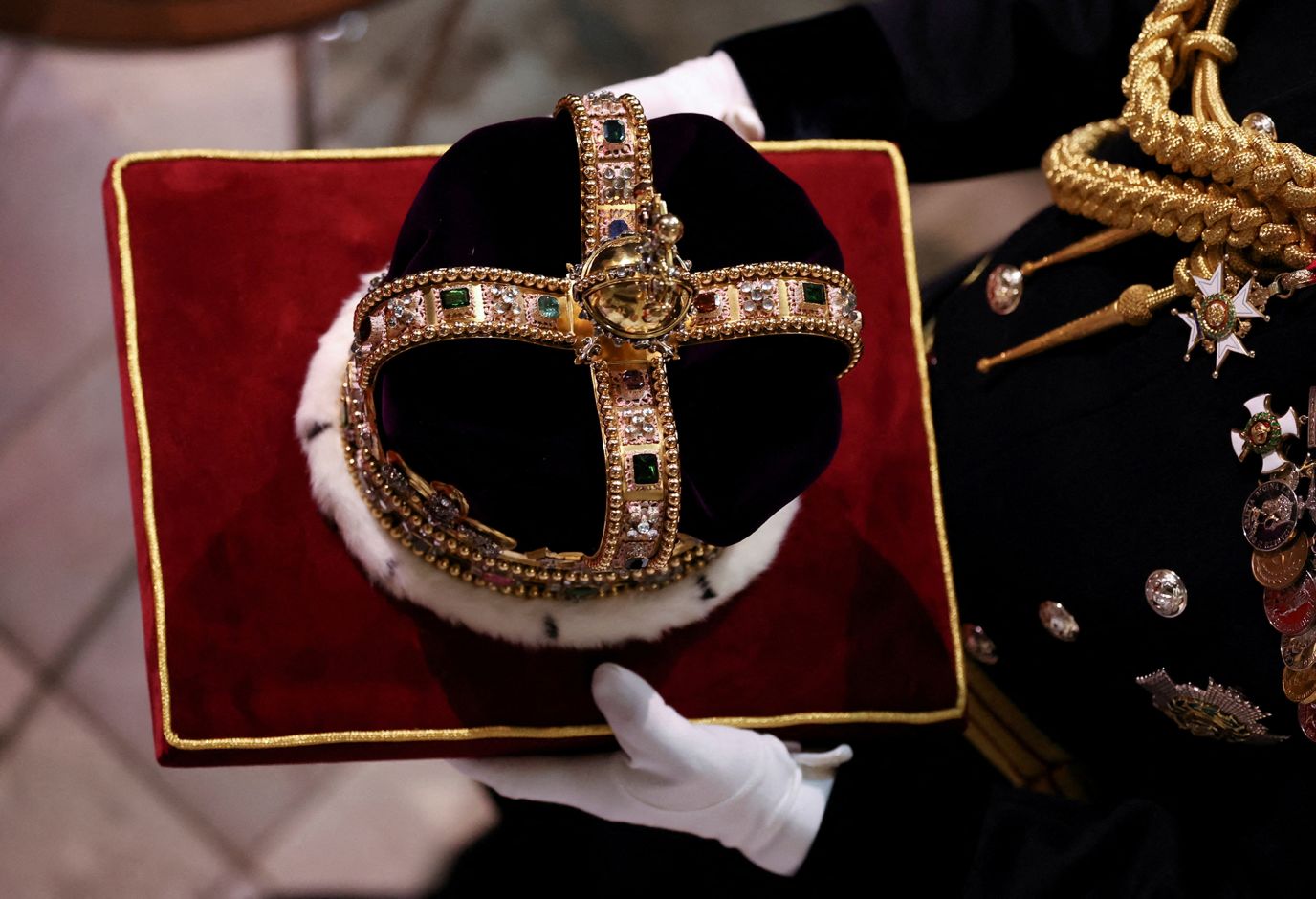 St Edward's Crown, which will be used to crown the King during the coronation, is carried inside Westminster Abbey.
