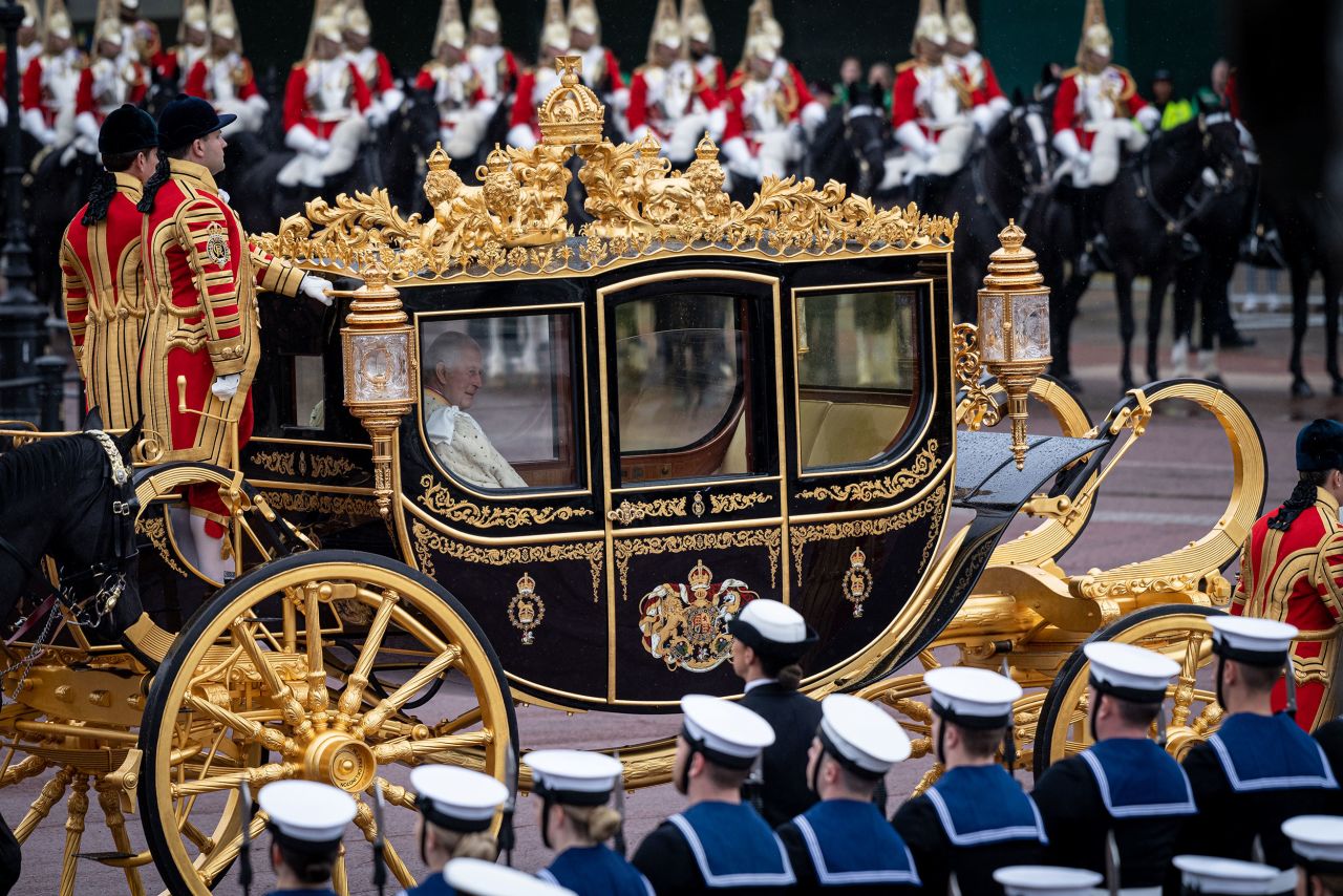 The King and Queen leave Buckingham Palace on their way to the coronation.
