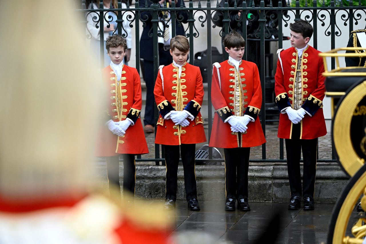 Prince George, second from left, stands with other pages of honor at Westminster Abbey.