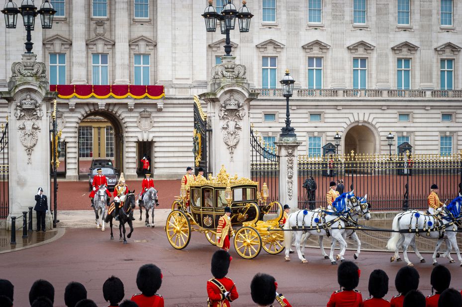 The King's carriage leaves Buckingham Palace before the coronation.