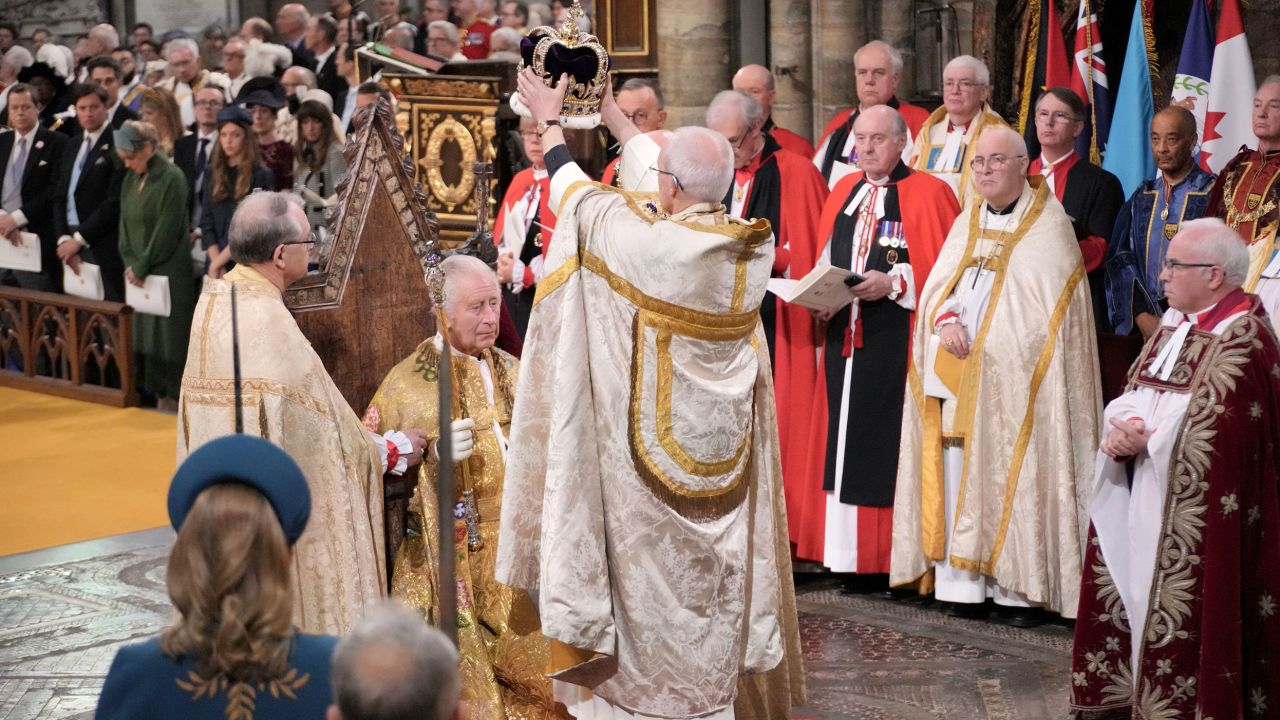 King Charles III sits as he receives The St Edward's Crown during the coronation ceremony.