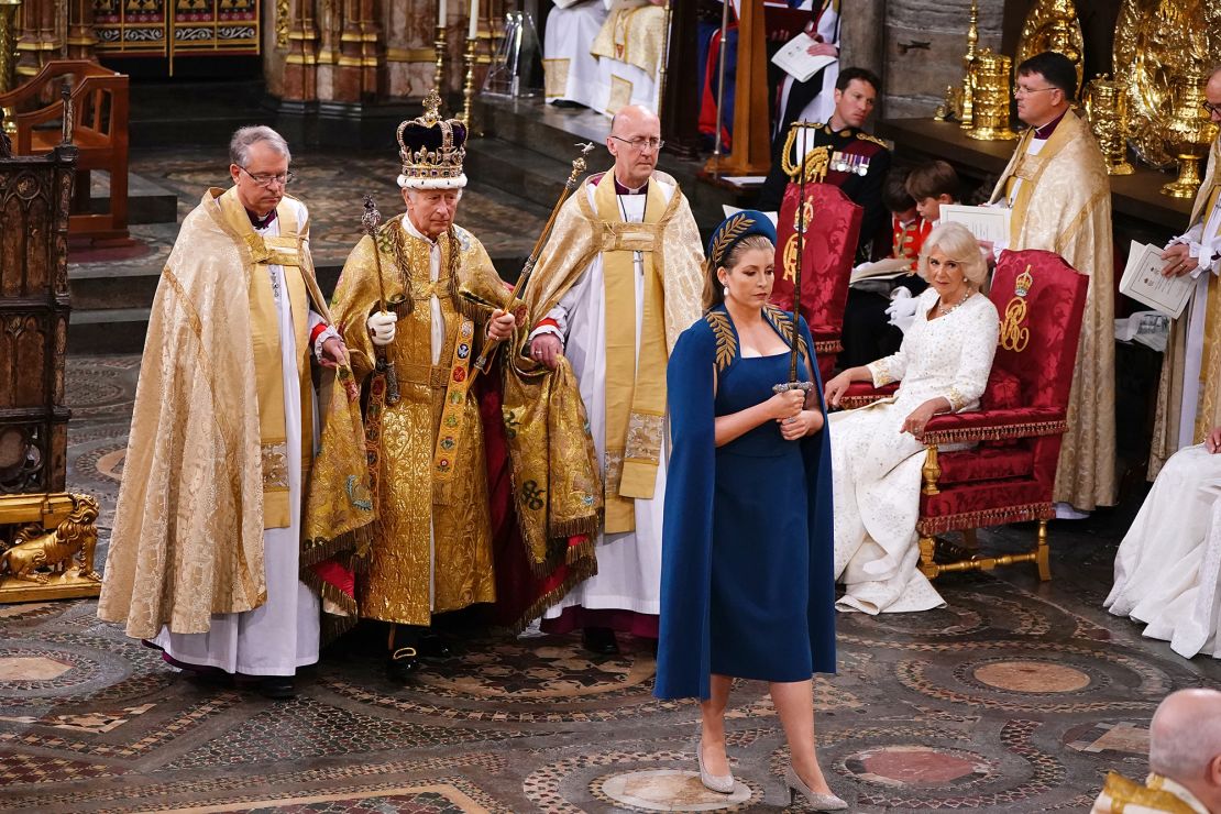 Penny Mordaunt leads King Charles III during his coronation ceremony in Westminster Abbey.