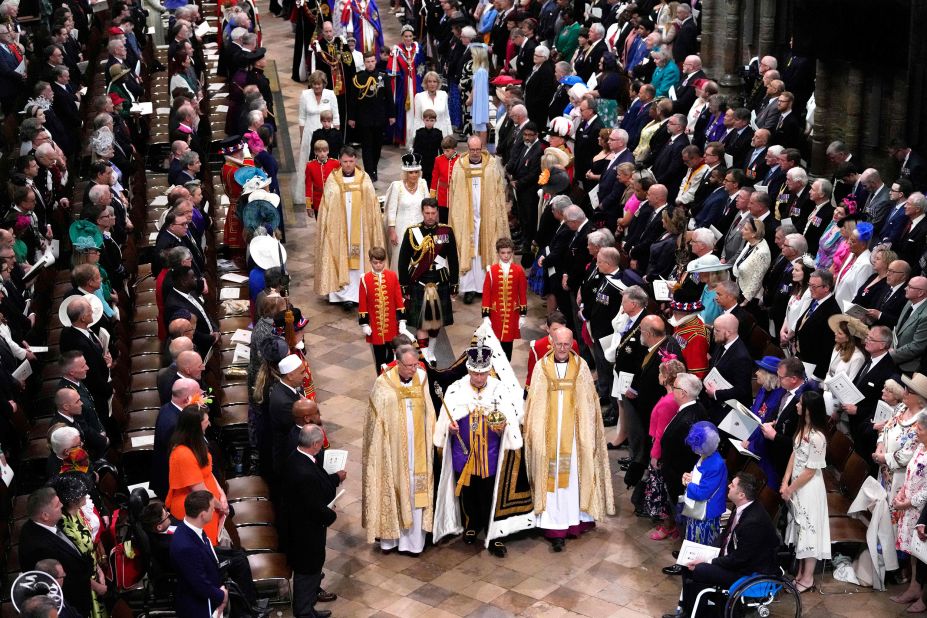 Charles and Camilla walk out of Westminster Abbey.