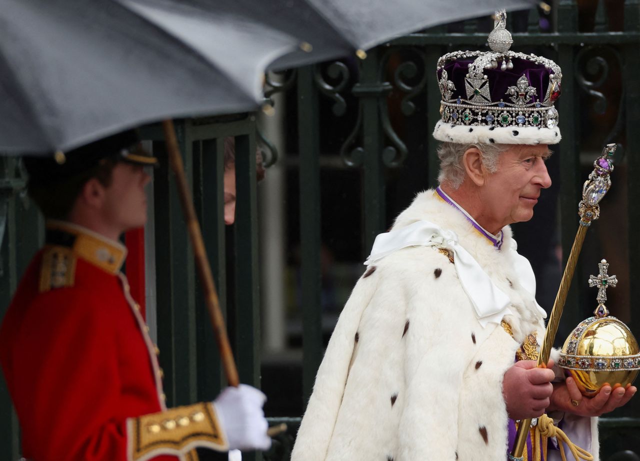 The King, wearing the Imperial State Crown, leaves Westminster Abbey after his coronation ceremony.