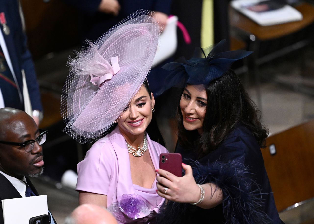 Nadia El-Nakla, the wife of Scottish First Minister Humza Yousaf, takes a selfie with singer Katy Perry at Westminster Abbey.