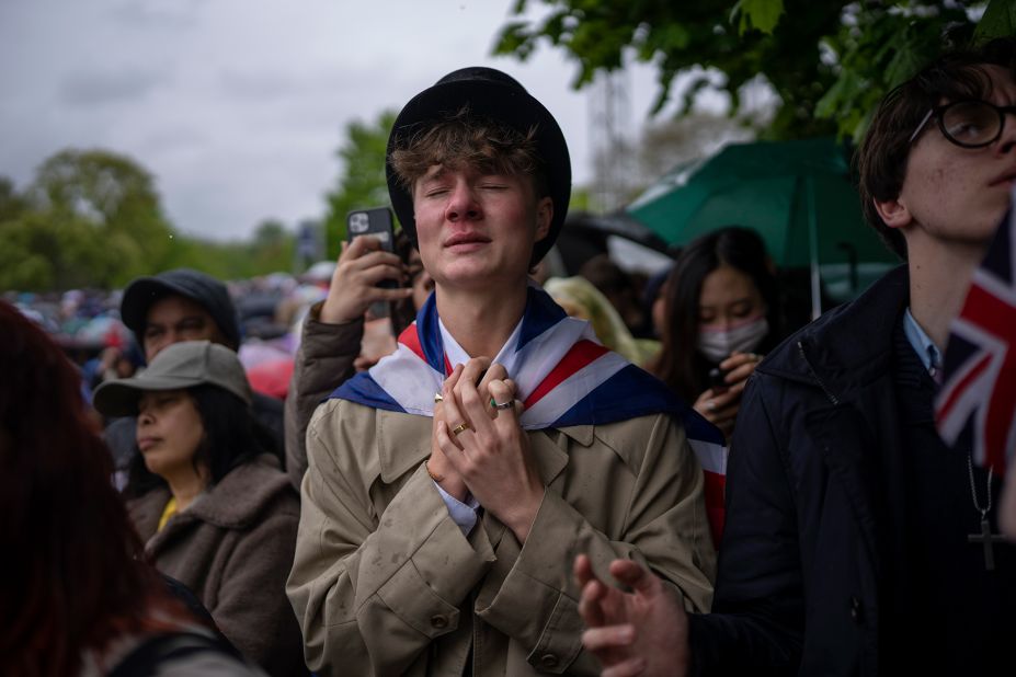 Royal fan Ben Weller reacts as he watches the coronation on a screen in London's Hyde Park.
