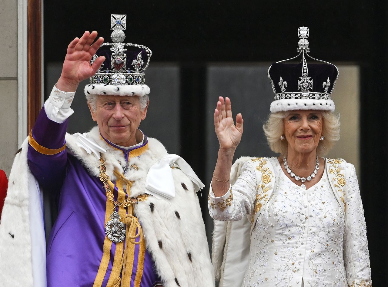 Charles and Camilla wave from the balcony of Buckingham Palace following their coronation.