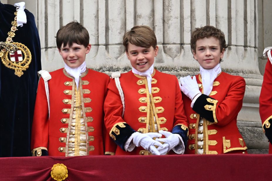 The King's eldest grandson, Prince George, stands on the palace balcony between two other boys who like him served as pages of honor for the coronation: Oliver Cholmondeley, left, and Nicholas Barclay.