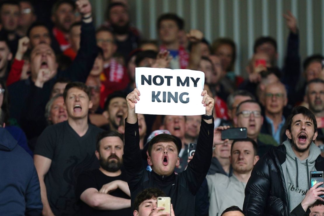 A Liverpool fan holds up a sign saying 'Not My King.'