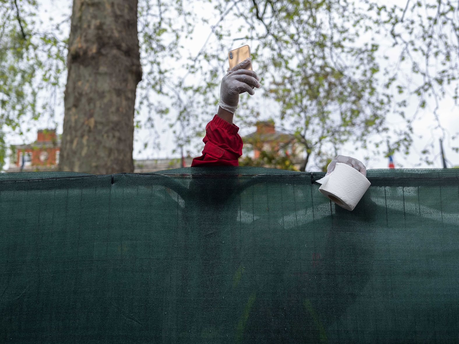 Akim, a worker cleaning some of the toilets along the route, takes a moment to capture the day on his phone.