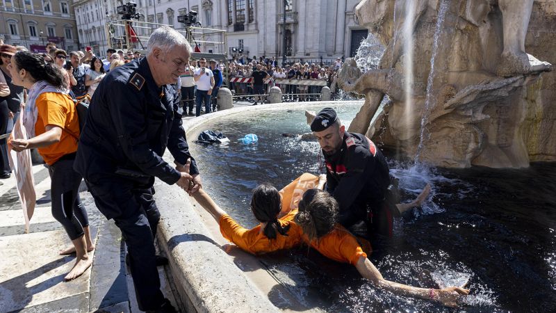 NextImg:Climate activists dye iconic Italian fountain water black | CNN