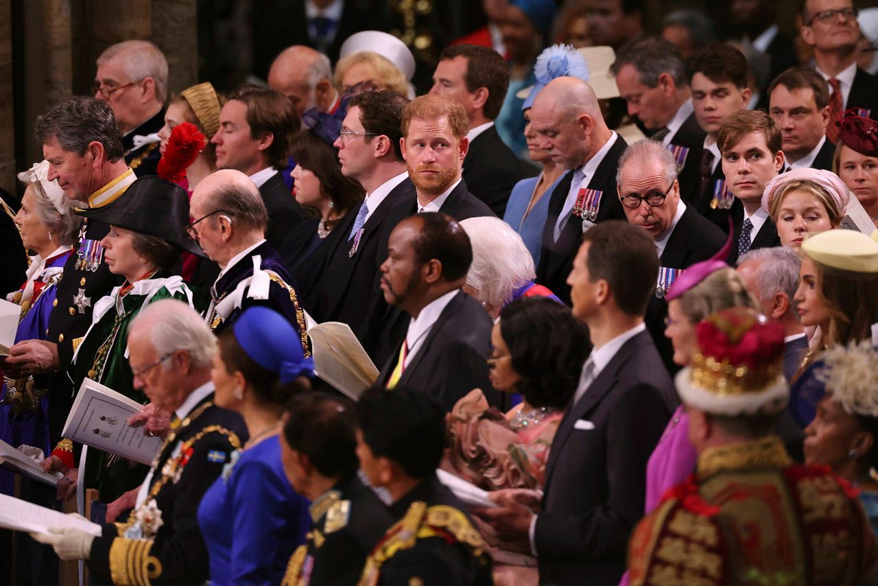 Prince Harry looks around Westminster Abbey from his spot in the third row. He is a non-working royal and did not perform any duties during the ceremony.