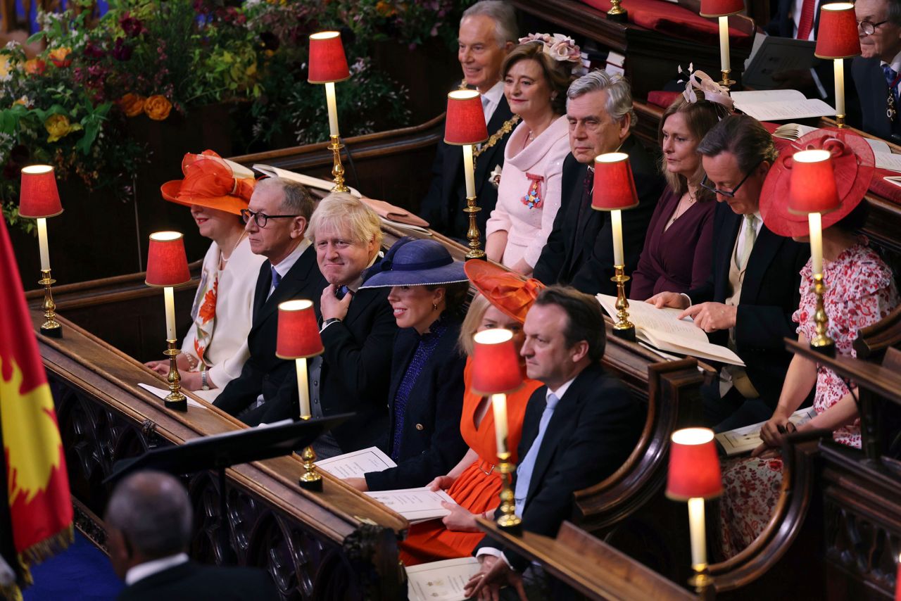 Former British prime ministers Tony Blair, Gordon Brown, David Cameron, Theresa May, Boris Johnson and Liz Truss sit with their partners.
