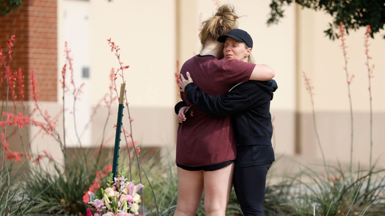 MacKenzie Bates (L), 17, of Allen, Texas, embraces her mother Rochelle on Sunday, the day after a mass shooting at Allen Premium Outlets in Texas.