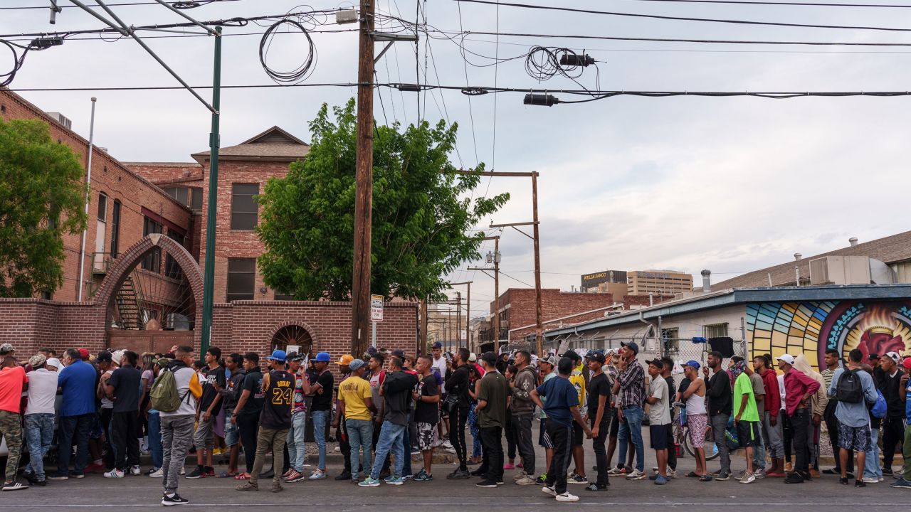 Migrants wait in line for donations outside of Sacred Heart Church in El Paso last Wednesday.