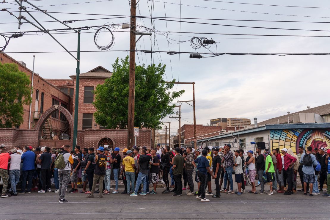 Migrants wait in line for donations outside of Sacred Heart Church in El Paso last Wednesday.