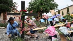 Muralist Roberto Marquez and his friend Israel Gil from Dallas erect a memorial to honor those who lost their lives when a gunman shot multiple people at the Dallas-area Allen Premium Outlets mall in Allen, Texas, U.S.  Robert says, 'This is like a refuge for the people who lost loved ones, a place where they can come and express all their emotions". He believes that the memorial is a priority for the difficult situation, people need a place to gather. May 7, 2023. REUTERS/Jeremy Lock