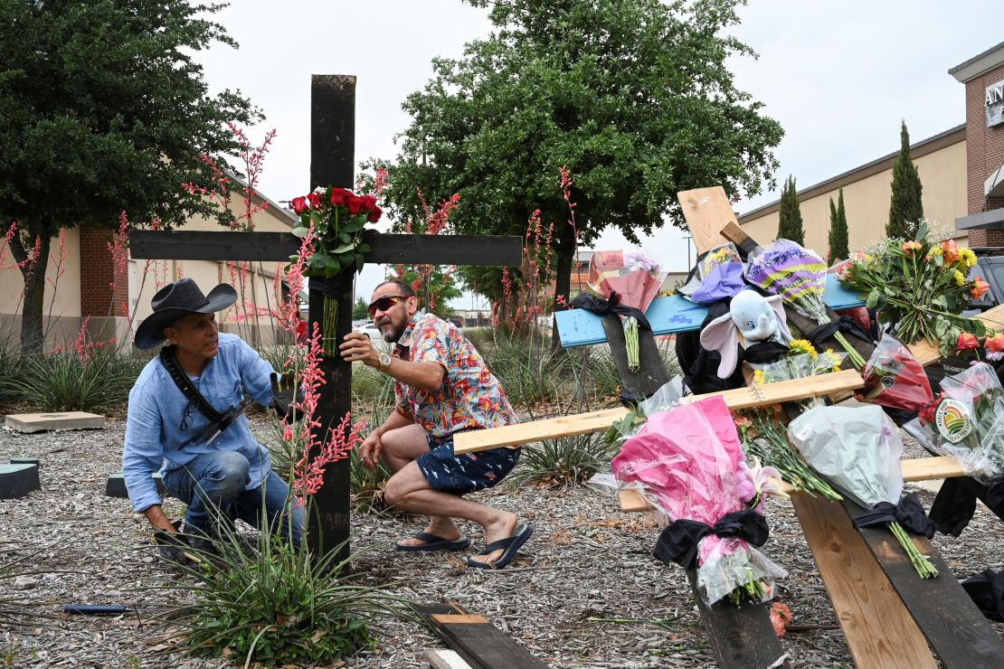 Muralist Roberto Marquez and his friend Israel Gil erect a memorial to honor the victims.