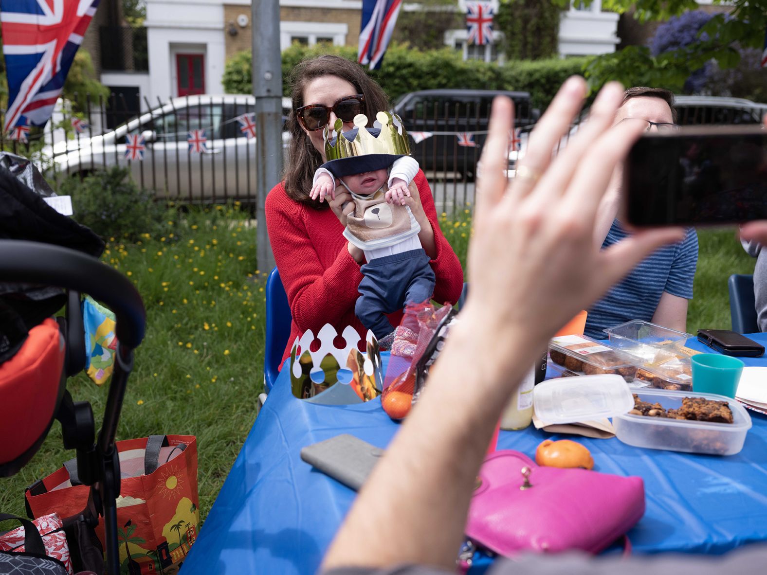 Joanne Lawson poses for a picture with 4-week-old baby Casper on Sunday. "This is his first party," she said.