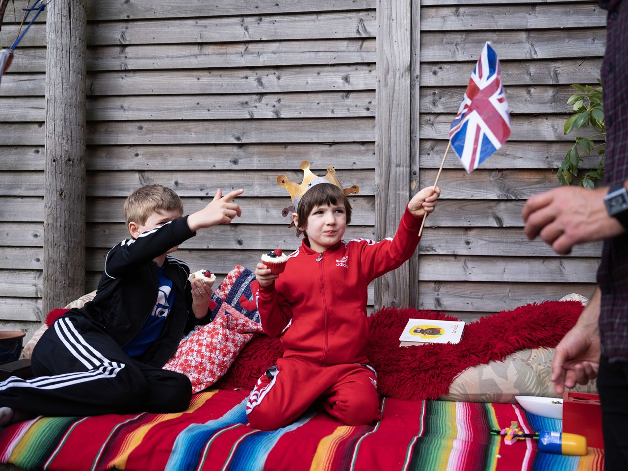 Sasha, 5, holds a Union Flag while eating a cupcake at a street party in North London.