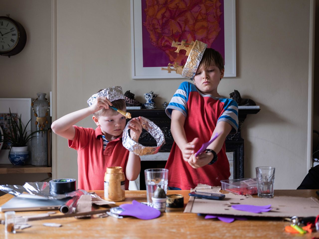 Brothers Frankie, 7, and Dylan, 9, make crowns at their home in London ahead of the coronation street parties on Sunday, May 7.