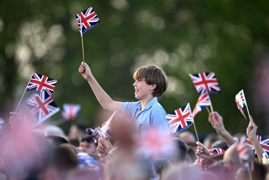 The crowd inside the Windsor Castle grounds waves flags as Sunday's "Coronation Concert" gets underway.
